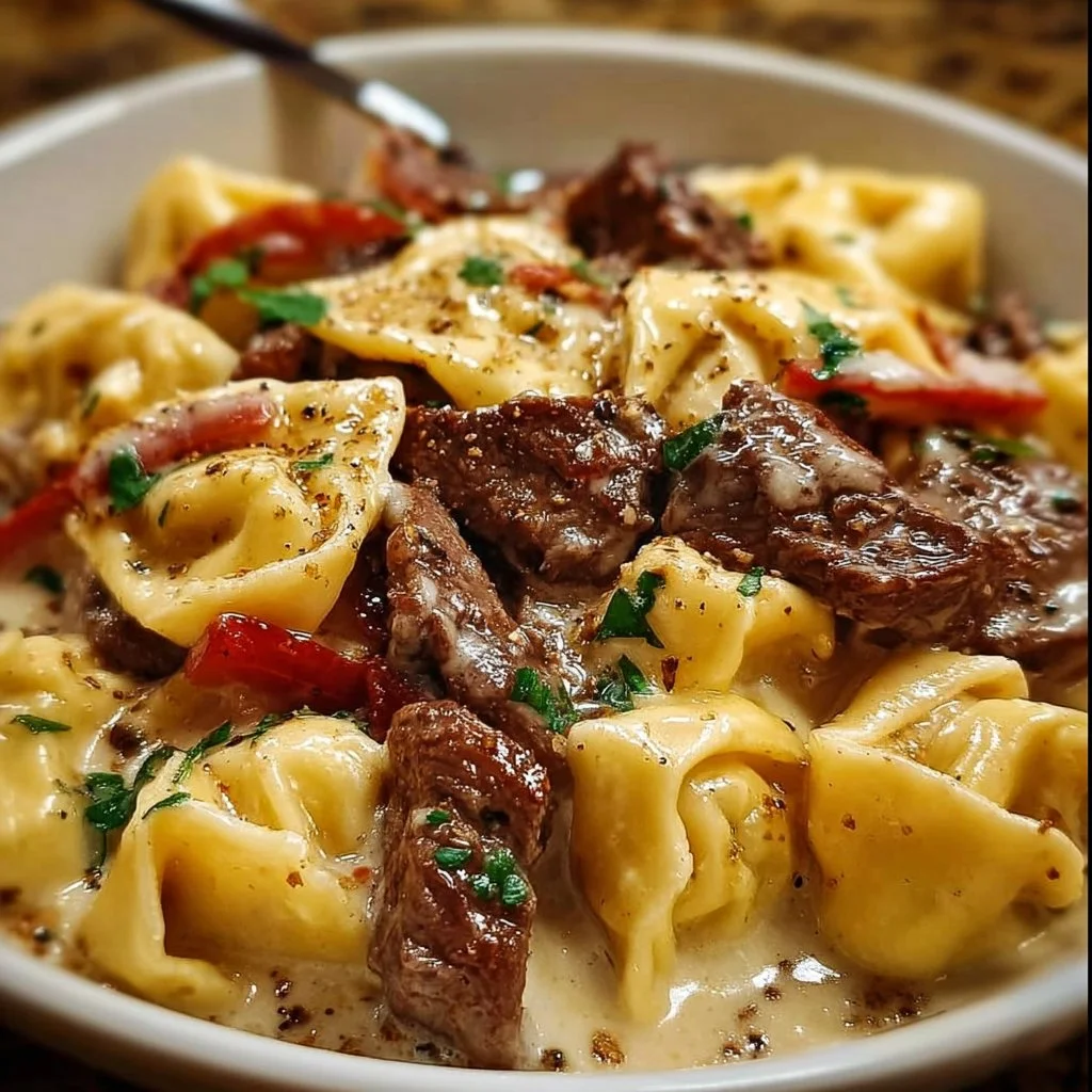 Delicious cheesesteak tortellini served with cheese and peppers