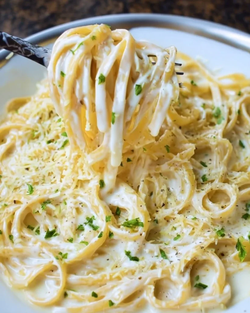 Delicious Olive Garden Alfredo Sauce served over pasta