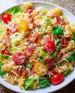 Colorful BLT Pasta Salad with bacon, lettuce, and tomatoes in a bowl