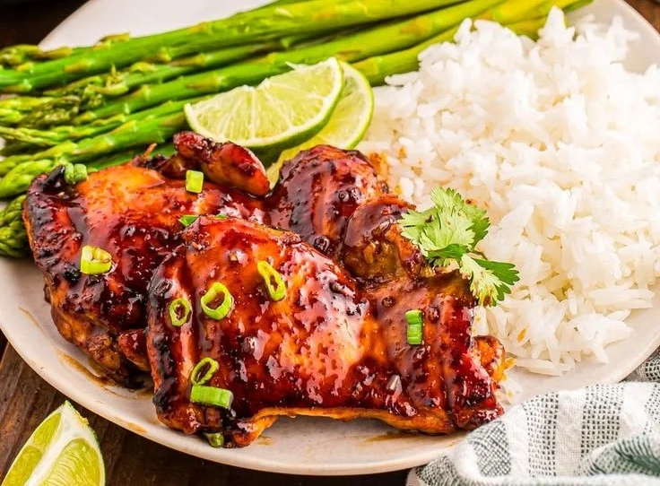 Delicious Honey Lime Chicken garnished with fresh herbs and lime slices.