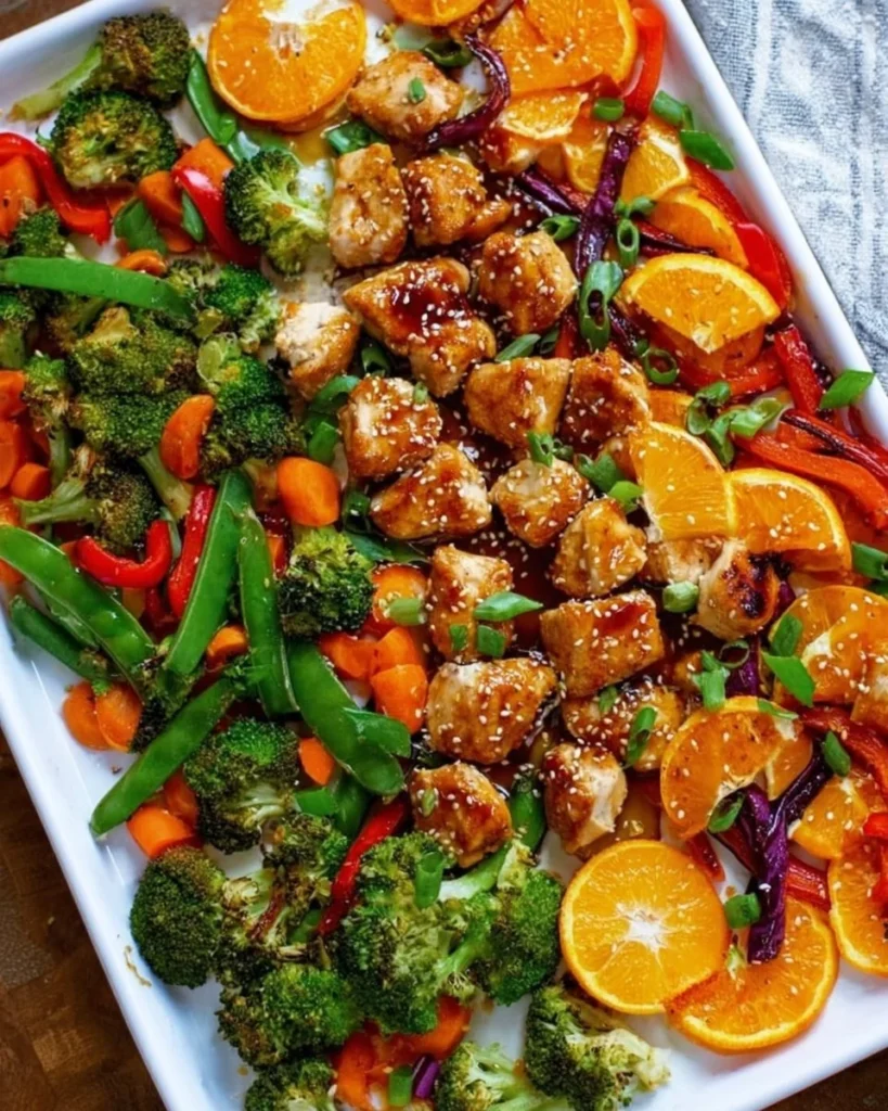 Sheet pan meal featuring orange chicken and colorful veggies