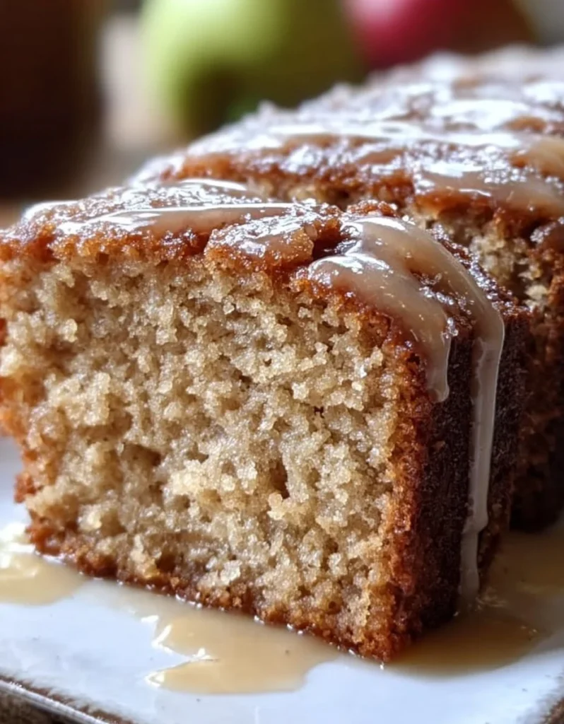 Amish Applesauce Cake with a slice removed, showcasing its moist texture and spices.