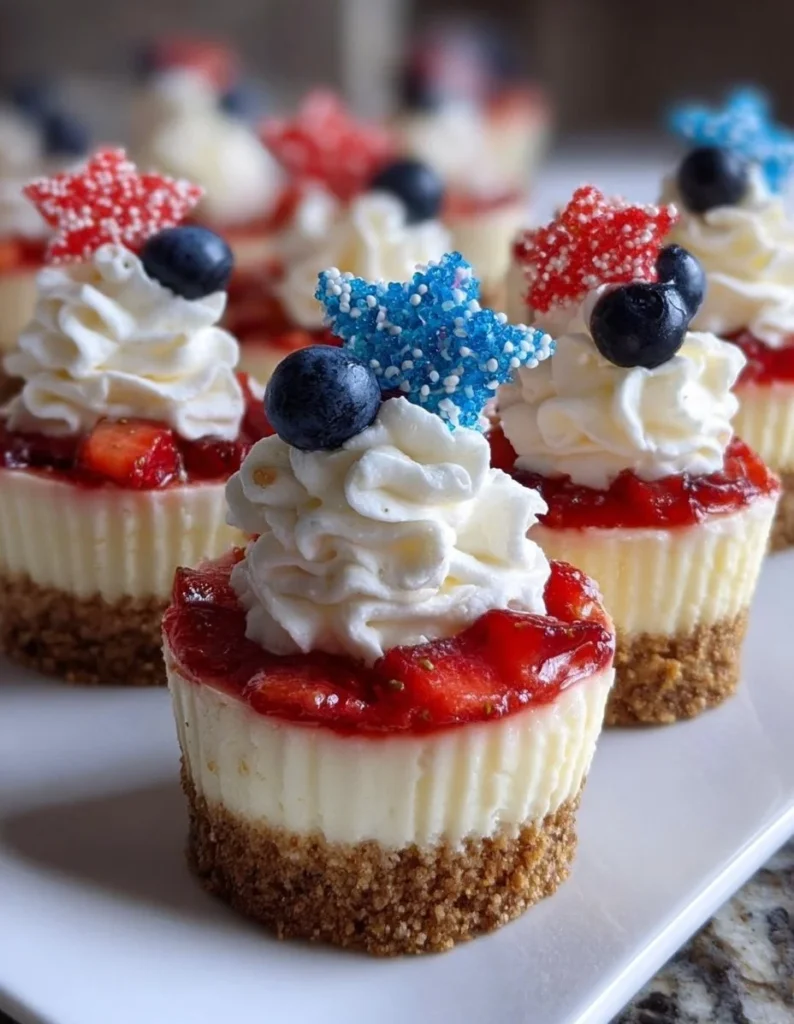 Red, White and Blue Mini Cheesecakes with fresh berries and whipped cream